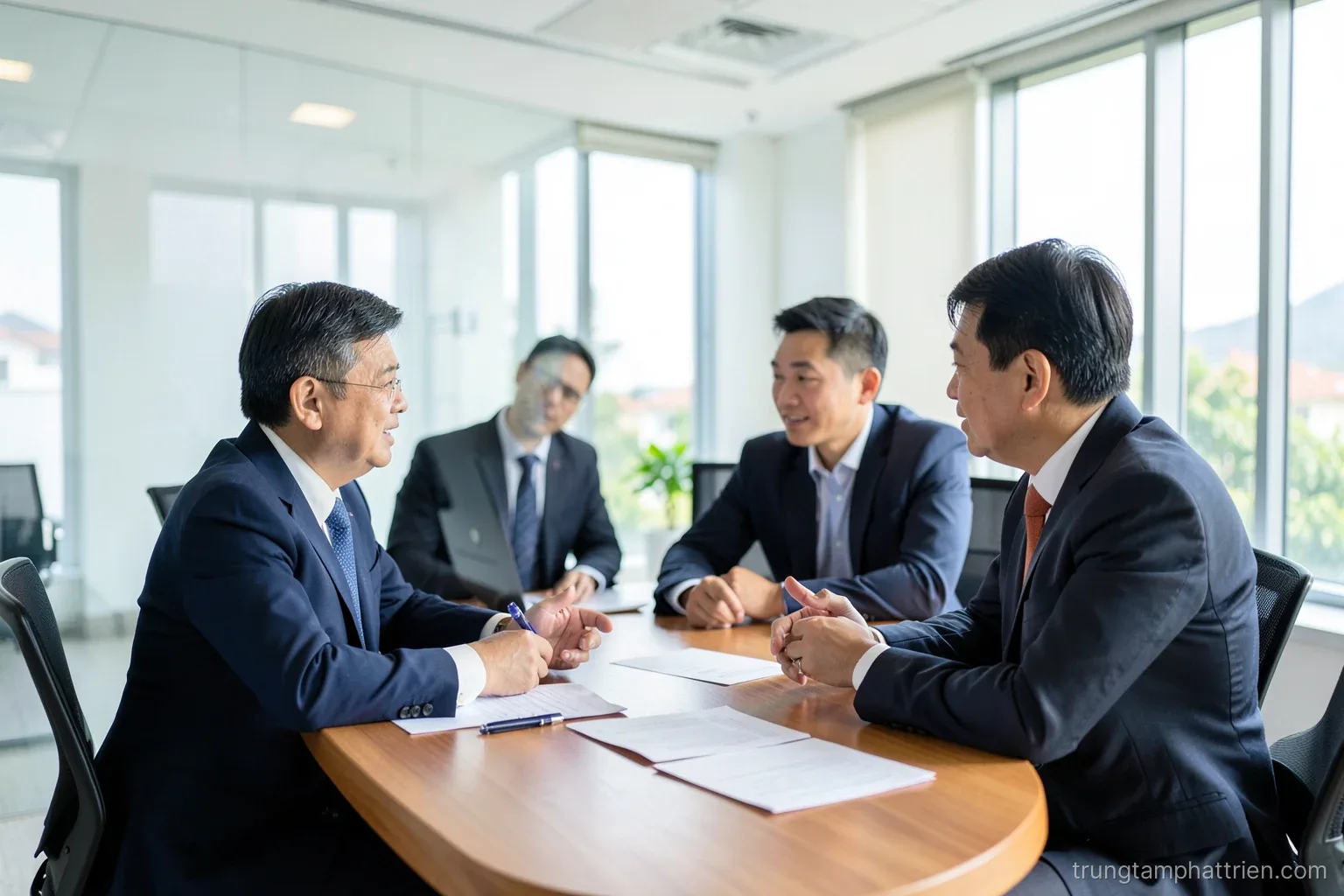 Over-the-shoulder shot of a Vietnamese analyst in a glass meeting room reviewing blank paper sheets beside a potted plant, city skyline blurred behind, cool blue and green tones